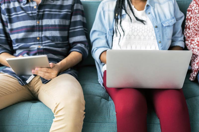 couple with laptop and tablet browsing websites